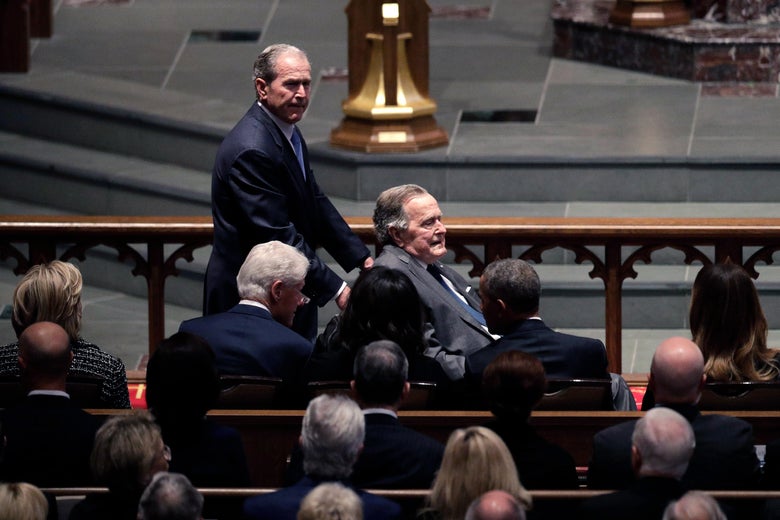 Former Presidents George W. Bush and George H.W. Bush arrive as they pass by former first lady Hillary Clinton, former President Bill Clinton, former first lady Michelle Obama, former President Barack Obama and first lady Melania Trump at St. Martin's Episcopal Church for a funeral service for former first lady Barbara Bush, April 21, 2018 in Houston, Texas.